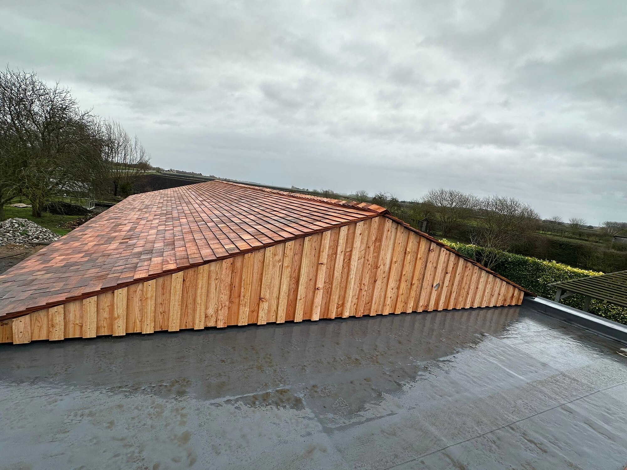 Scottish larch cladding and cedar shingle roof, The Birch Room