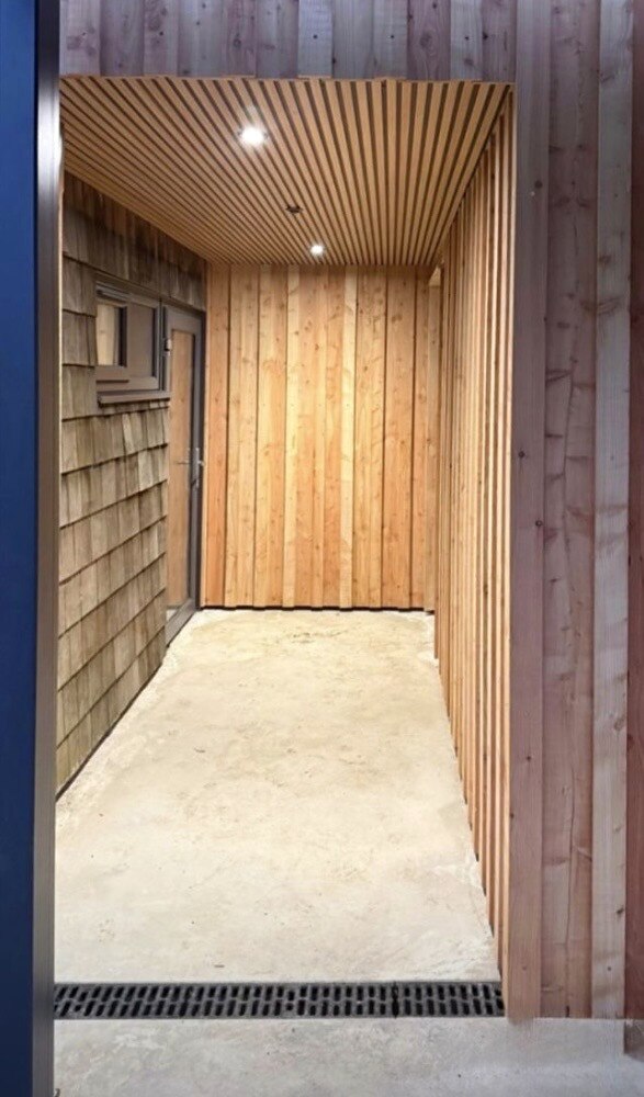 Covered porch entrance with cedar shingle cladding, The Birch Room